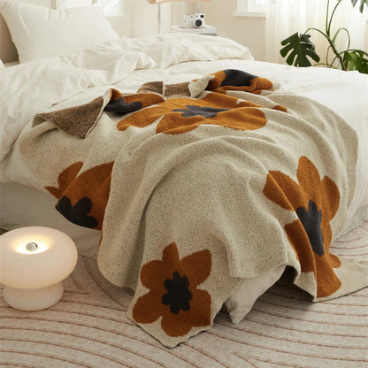 Cosy floral knitted throw blanket in red, featuring a chic bohemian design and luxurious microfibre fabric for maximum comfort and style.