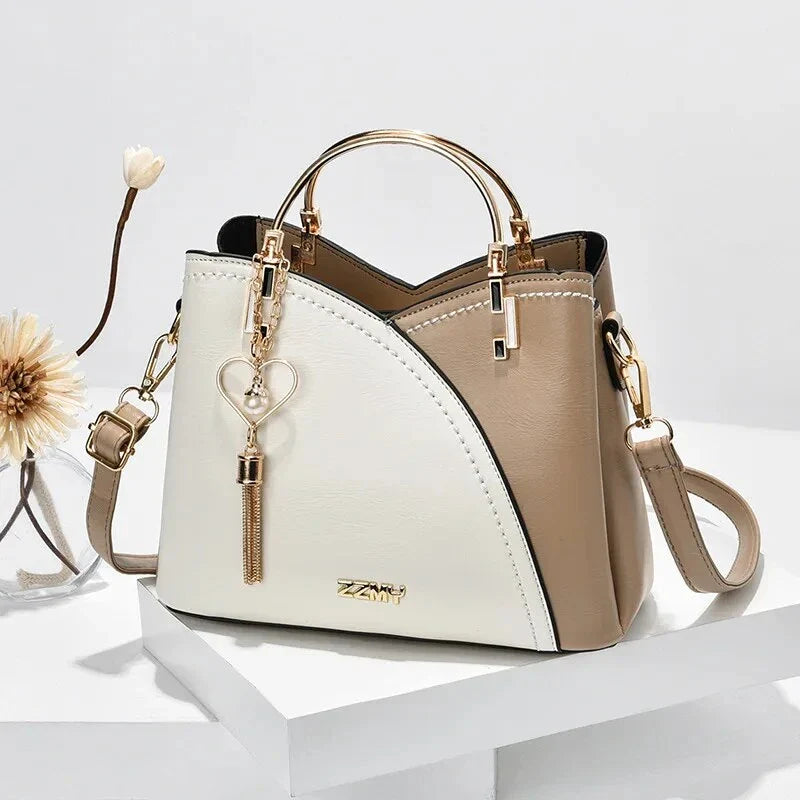 Sophisticated navy blue PU leather bucket crossbody bag with elegant patchwork design and adjustable strap