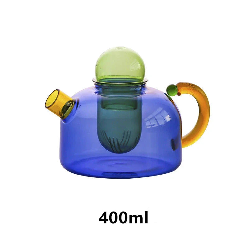 Elegant colourful glass teapot and teacup set with vibrant contrasting colours, perfect for tea and coffee enjoyment