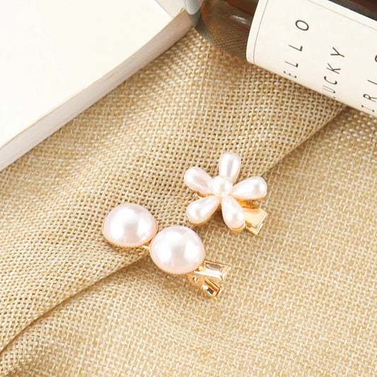 Elegant silver-toned hair clip with a beautiful pearl flower design, a timeless British-inspired accessory