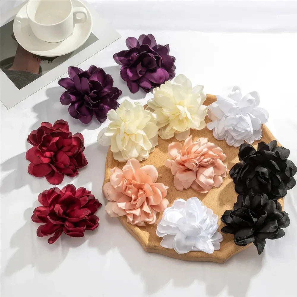 Exquisite fluffy fabric flower stud earrings in a black metal colour, featuring oversized fabric blooms for a unique and elegant design.