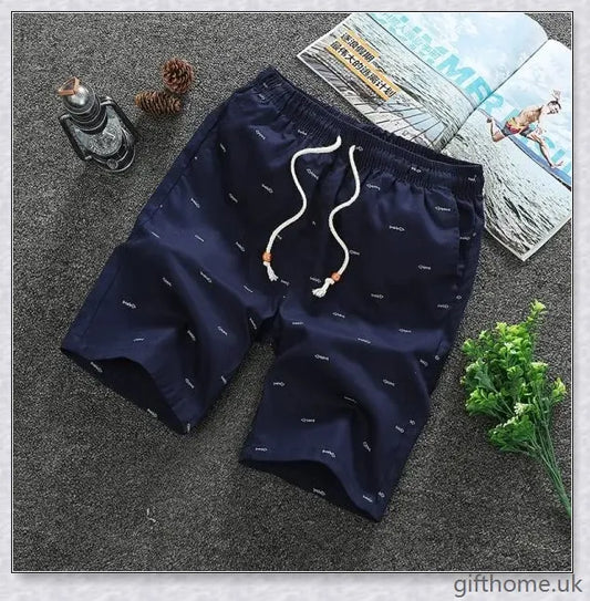 Pair of premium cotton beach shorts in navy blue, khaki, and slate grey colours, perfect for stylish seaside adventures
