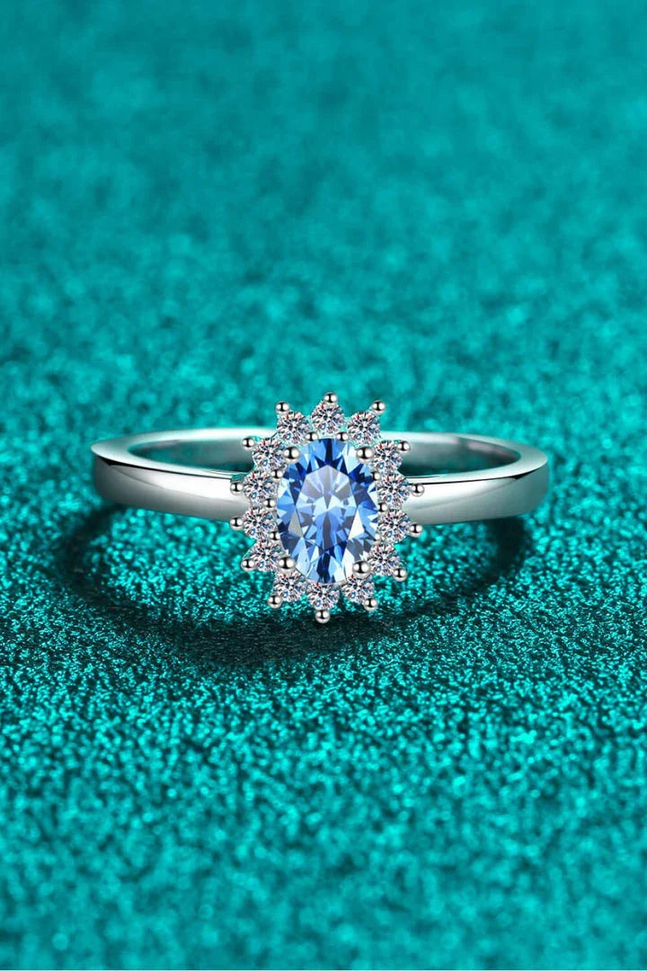 A close-up of a minimalist, polished 925 sterling silver ring with a dazzling moissanite centre stone