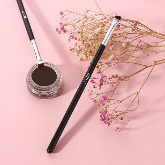 Professional black eyebrow and eyeliner makeup brush with sleek wooden handle for precise, salon-quality results