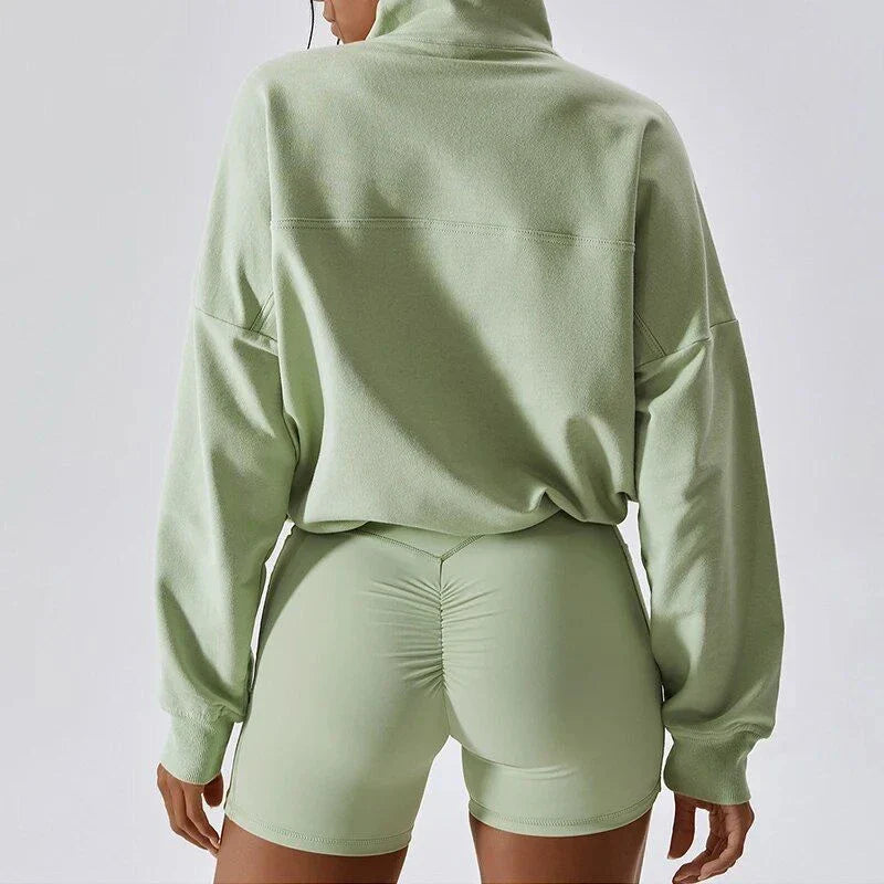 A cosy, oversized cotton pullover with a stylish zipper accent, perfect for casual autumn and winter wear.