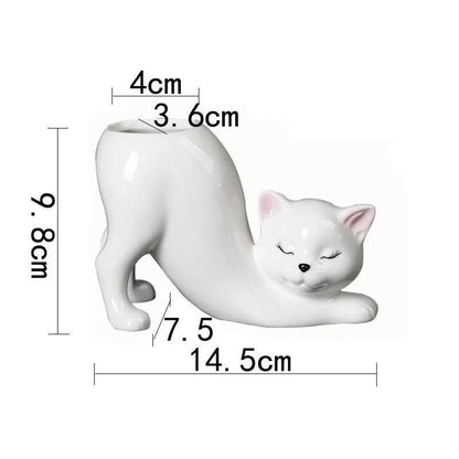A white ceramic flower pot with a playful cartoon cat design and a functional tail element, perfect for desktops and small spaces.