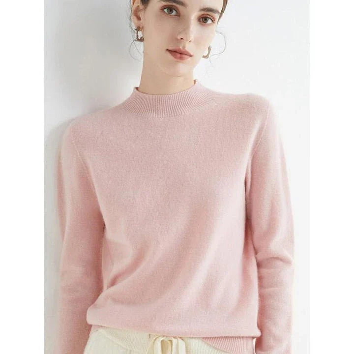 A woman wearing a luxurious Merino wool mock-neck jumper in a stylish autumnal outfit