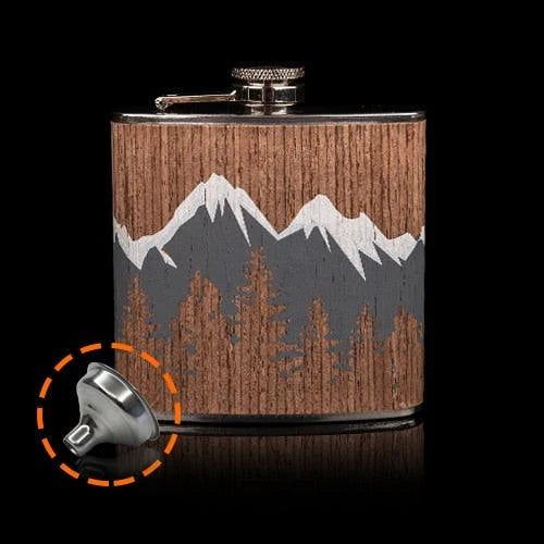 Stylish mountain-themed stainless steel and wood hip flask with optional glasses, perfect for outdoor adventures and social gatherings.
