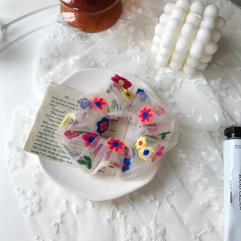 Handmade floral elastic hair bands with soft chiffon fabric and vibrant embroidered daisy patterns, perfect for enhancing everyday style in the UK.