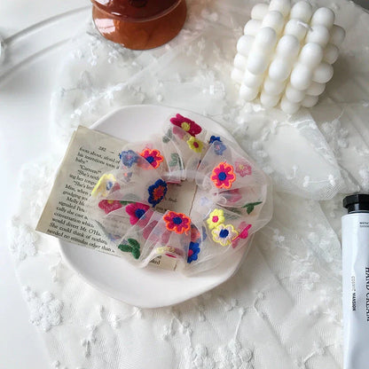 Handmade floral elastic hair bands with soft chiffon fabric and vibrant embroidered daisy patterns, perfect for enhancing everyday style in the UK.