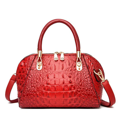 Premium leather one-shoulder messenger bag in various colours, featuring a sleek, shell-inspired silhouette and multiple internal pockets for organisation.