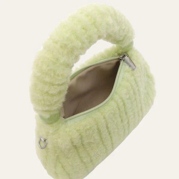 A luxurious faux fur hobo handbag with a stylish baguette shape and secure zipper closure