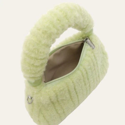 A luxurious faux fur hobo handbag with a stylish baguette shape and secure zipper closure