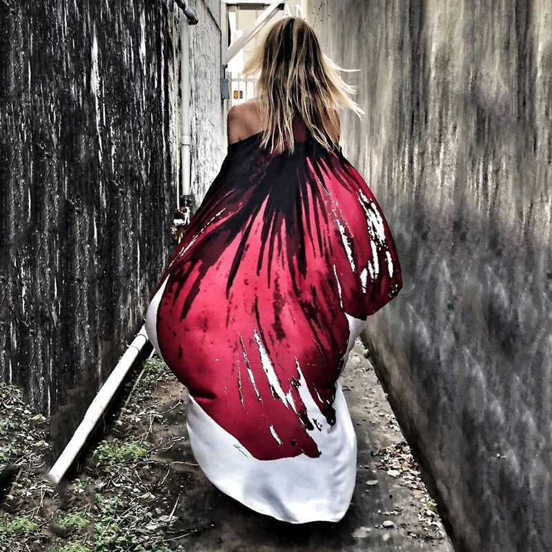 A chic inclined shoulder printed dress in a vibrant colour with a large, swinging skirt
