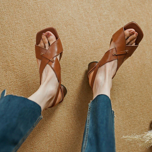 Elegant leather high heel sandals for women, featuring a refined square heel, stylish buckle strap, and sleek design for a sophisticated look.