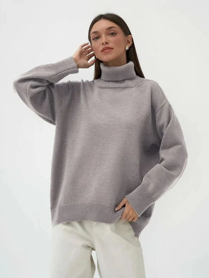 Cosy oversized knitted pullover in blue, featuring a classic turtleneck collar and drop-shoulder silhouette for maximum comfort and style.