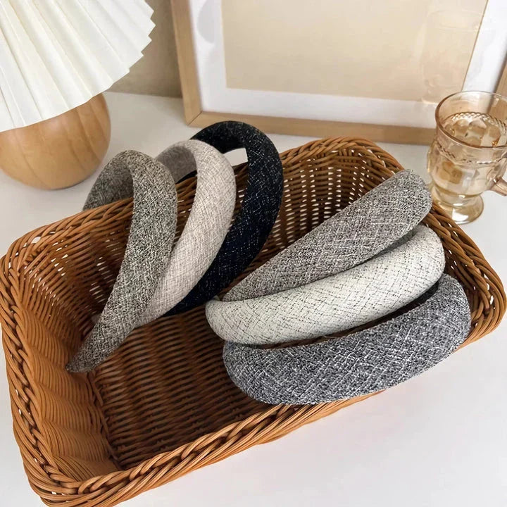 A stylish wide hairband in a classic plaid pattern, offering a chic and sophisticated look for British women.