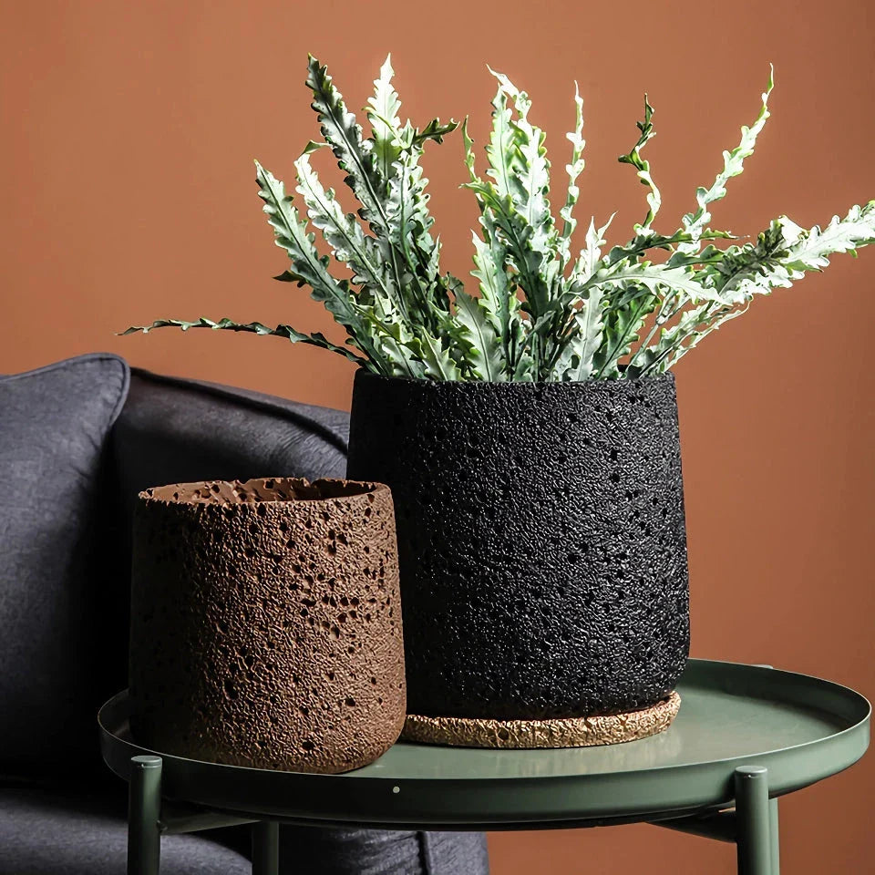 A modern, perforated cement bonsai planter in a Nordic-inspired design, available in various sizes and colours.