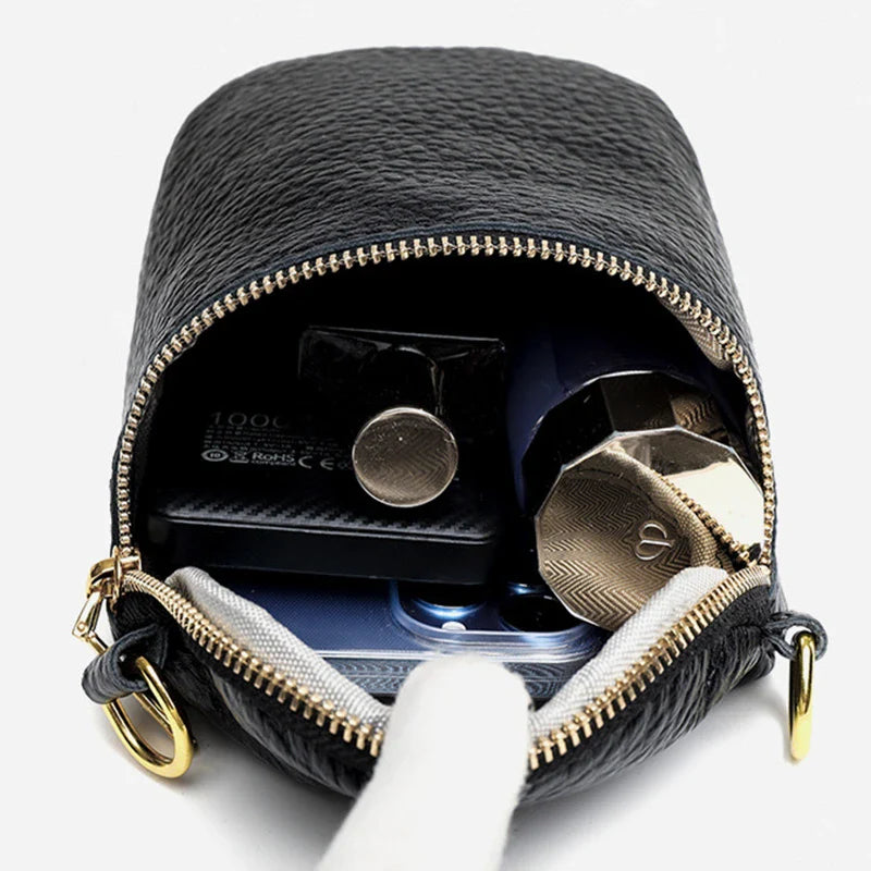 Elegant leather crossbody bag with adjustable strap, multiple pockets, and premium cowhide construction for the modern British woman