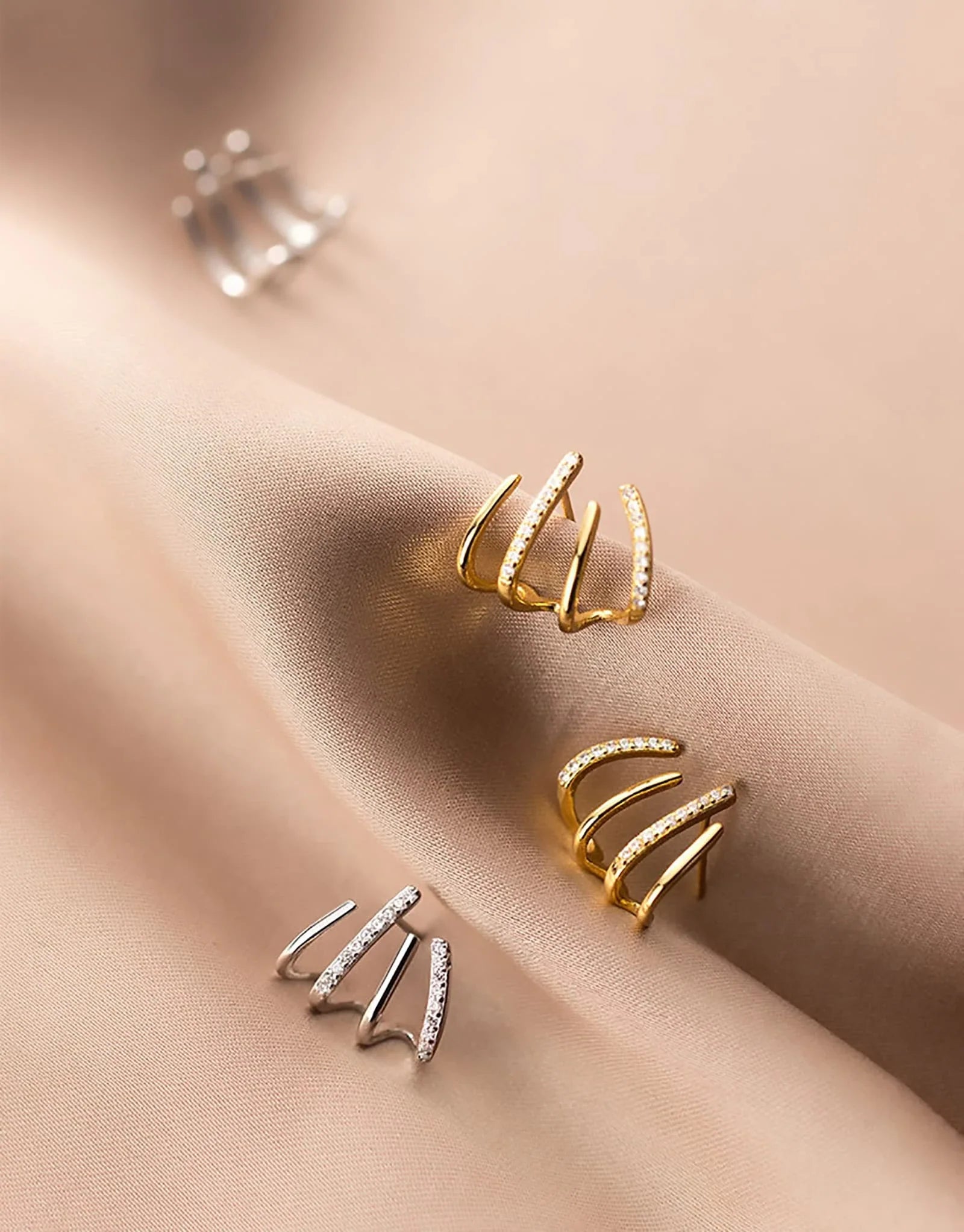 Exquisite zircon four-claw stud earrings in a gleaming gold colour, showcasing a timeless and elegant design
