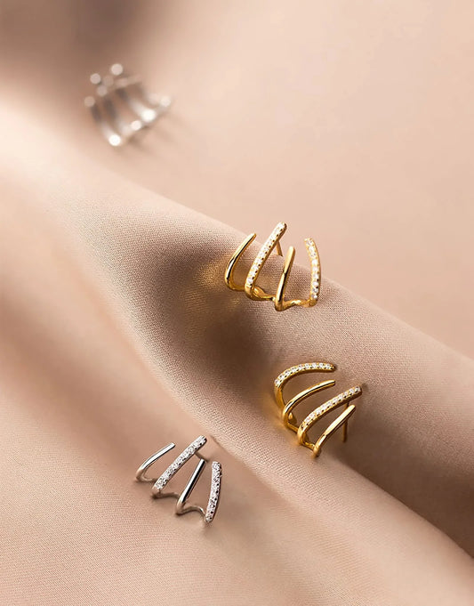 Exquisite zircon four-claw stud earrings in a gleaming gold colour, showcasing a timeless and elegant design