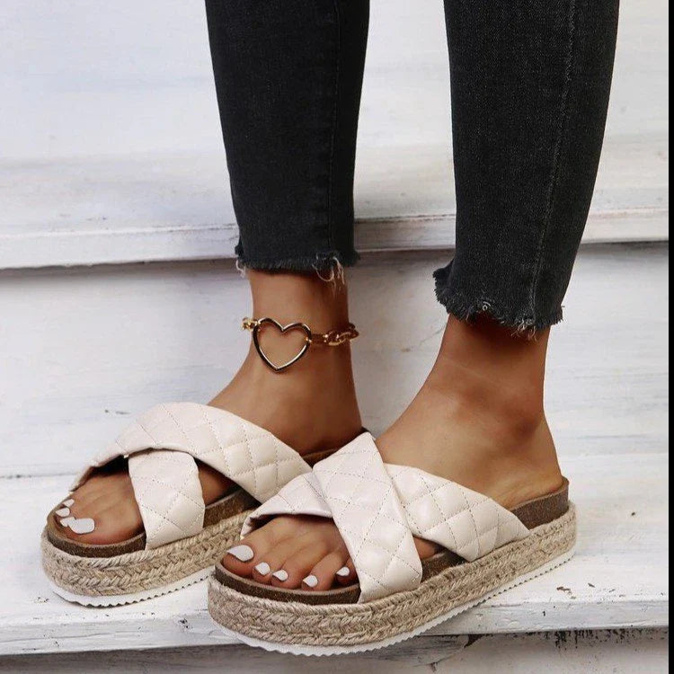 Elegant cross-toe platform sandals and slippers in a neutral creamy white hue, showcasing a contemporary and refined design for the discerning woman