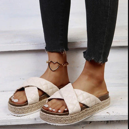 Elegant cross-toe platform sandals and slippers in a neutral creamy white hue, showcasing a contemporary and refined design for the discerning woman