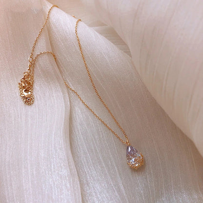 Close-up shot of a silver-plated crystal water drop pendant necklace on a plain background