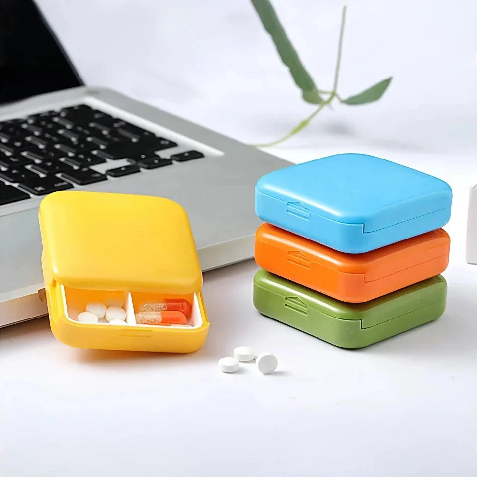 Compact push-pull pill case organiser in various vibrant cartoon-inspired colours for convenient medication management
