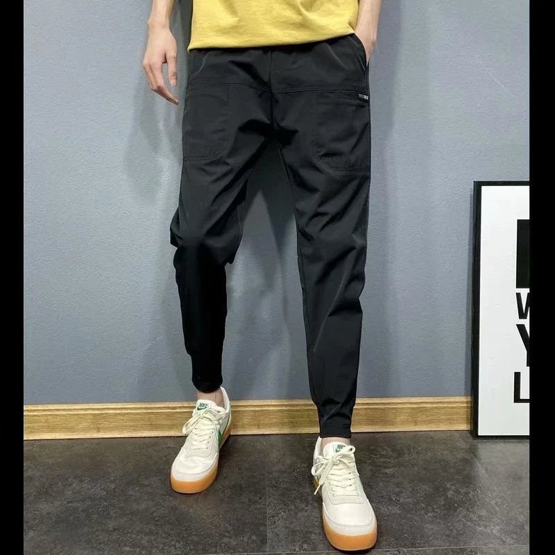Premium slim-fit drawstring joggers in black and grey, featuring a tailored silhouette and adjustable waistband for a polished, comfortable look.