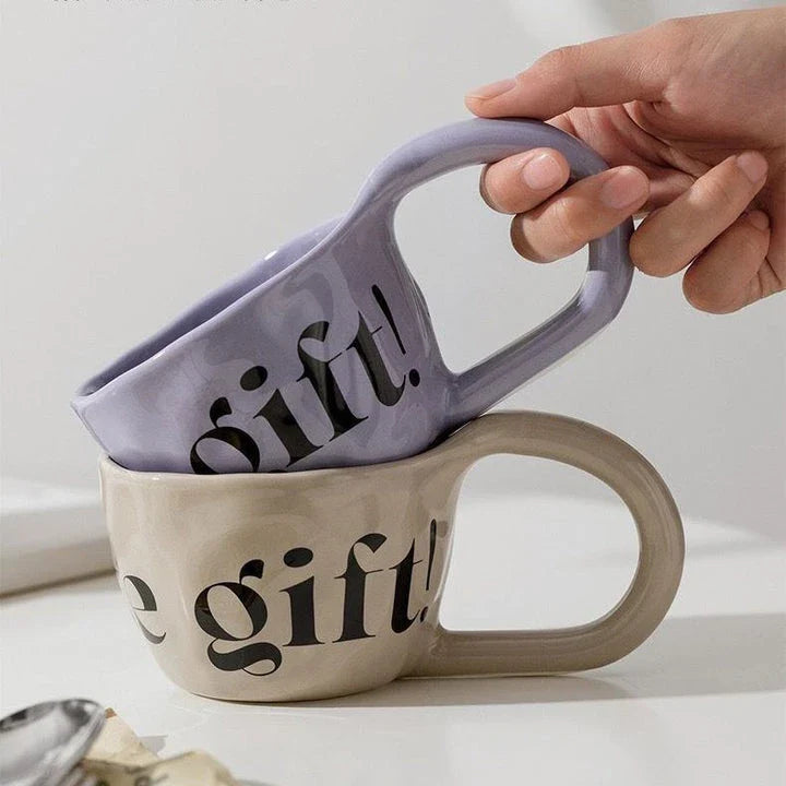 Handcrafted creative alphabet ceramic mug in beige, purple, and khaki colours for hot drinks like coffee and tea