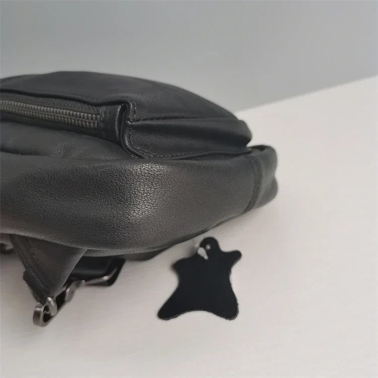 Premium black leather chest bag with zipper closure, adjustable strap, and ample storage space for everyday essentials