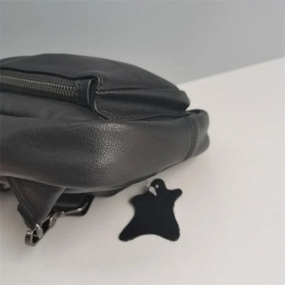 Premium black leather chest bag with zipper closure, adjustable strap, and ample storage space for everyday essentials
