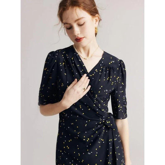 Sophisticated black polka dot silk wrap dress with a flattering V-neck and empire waistline, suitable for various occasions.