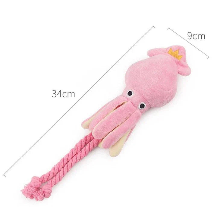 A soft, plush pink squid-shaped dog toy with a vibrant and whimsical design