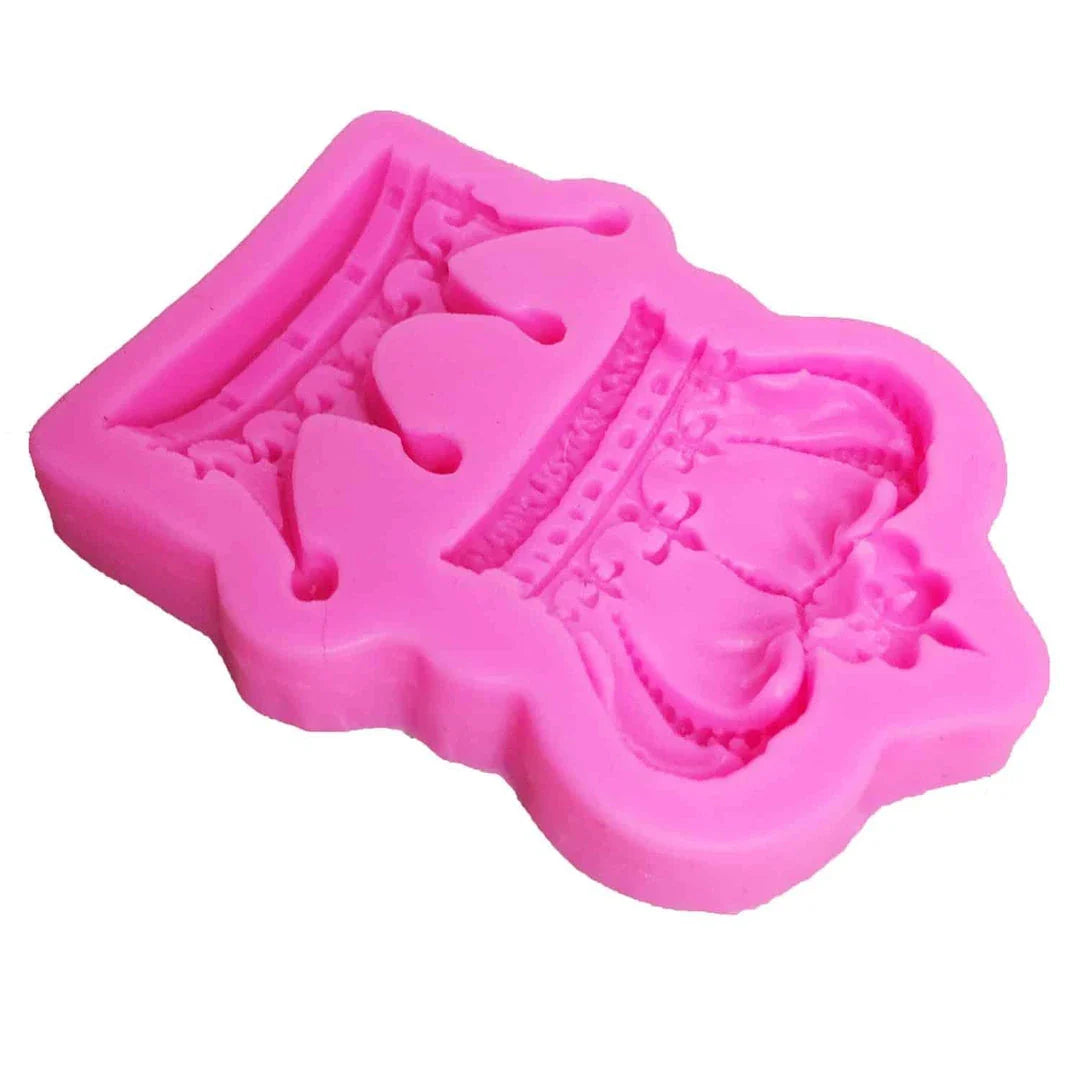 Elegant crown-shaped silicone fondant mould in vibrant pink colour for creating regal-inspired baked goods
