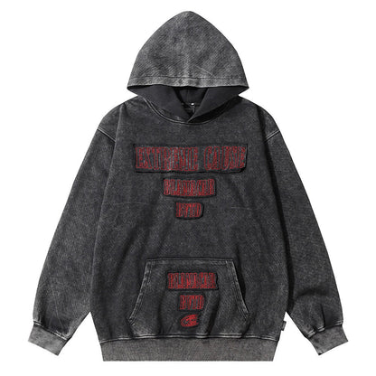 Embroidered cotton hoodie with a letter patch design, available in brown, grey, and black colours and sizes S to XL
