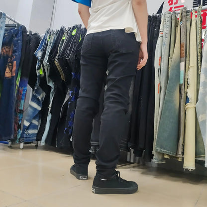 Premium ripped black jeans with stylish green patchwork design, made with medium-elastic fabric for comfort and a slim, flattering silhouette.