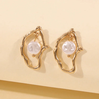 Irregular pearl earrings in a gold colour, featuring a unique and stylish design for versatile wear