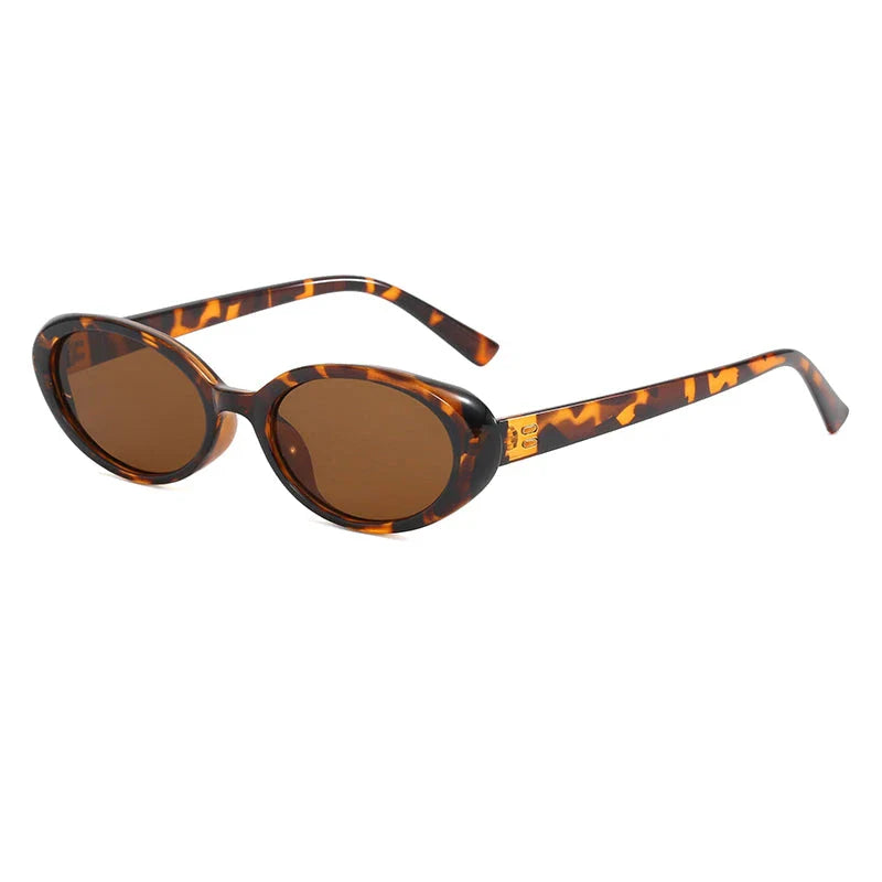 Oval-shaped women's sunglasses in a white and grey colour, offering UV protection and a stylish, retro-inspired design.