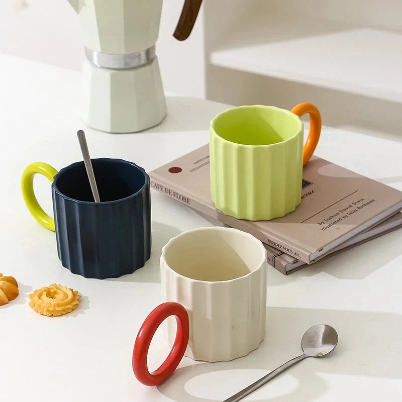 Japanese-style ceramic coffee mug with a unique ripple handle design, perfect for hot and cold beverages