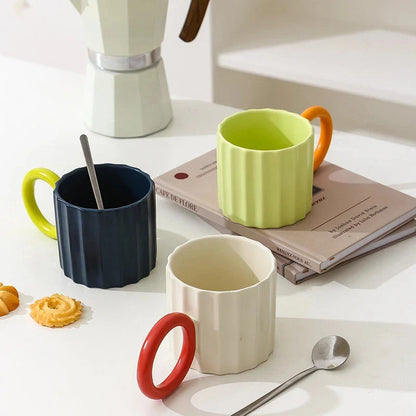 Japanese-style ceramic coffee mug with a unique ripple handle design, perfect for hot and cold beverages