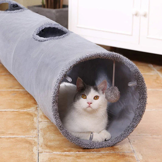 A collapsible cat tunnel made of crinkle suede with a peek-a-boo hole and dangling ball, providing a stimulating and entertaining play experience for cats.
