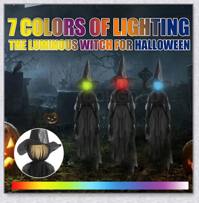 Three tall, black-robed witch figures with faceless glowing heads, standing together and holding hands, creating a spooky outdoor Halloween display