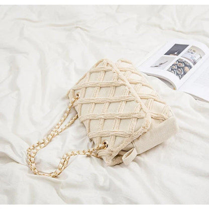 A stylish, retro-inspired shoulder bag with a minimalist rhombus pattern design, perfect for the modern, fashion-conscious woman in the UK.