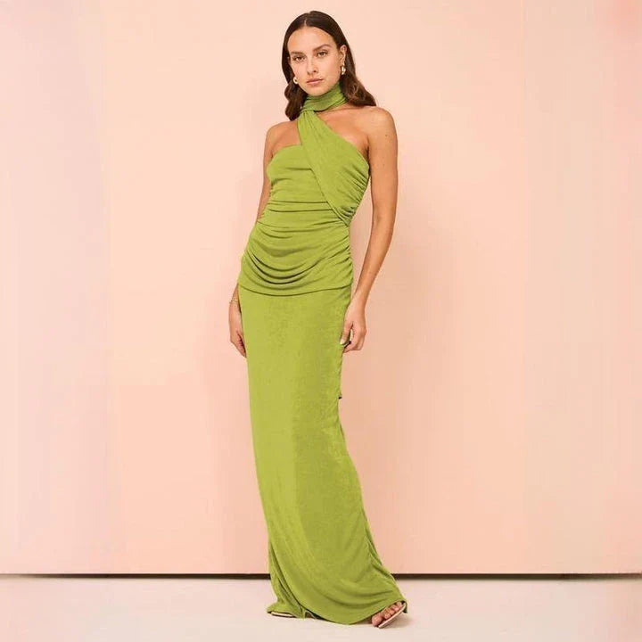Elegant halter backless ankle-length bodycon dress in a solid colour, designed to flatter the figure and create a sophisticated, eye-catching look for formal events.