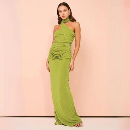 Elegant halter backless ankle-length bodycon dress in a solid colour, designed to flatter the figure and create a sophisticated, eye-catching look for formal events.