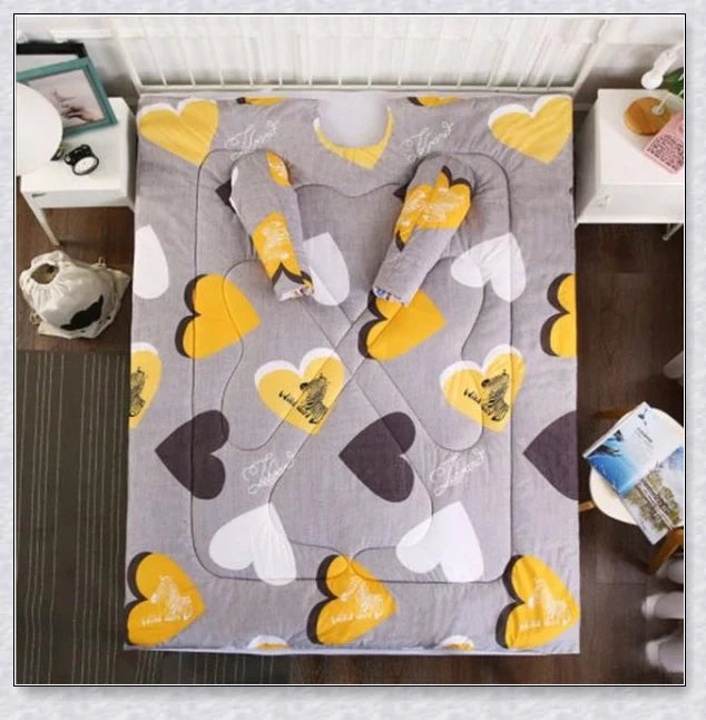 A cosy, wearable quilt with sleeves in a variety of colourful designs, perfect for staying warm and comfortable during the winter months.