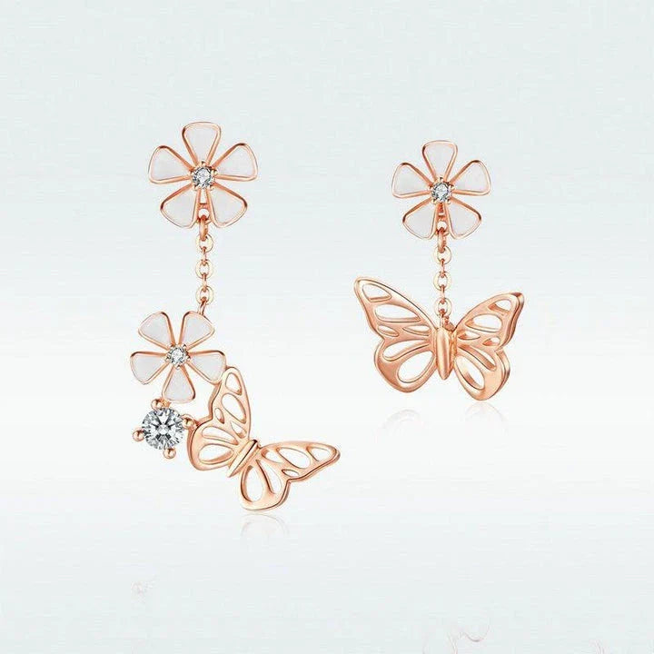 Pair of silver earrings featuring a butterfly-shaped floral design with sparkling white crystals, inspired by the enchanting Forest Series