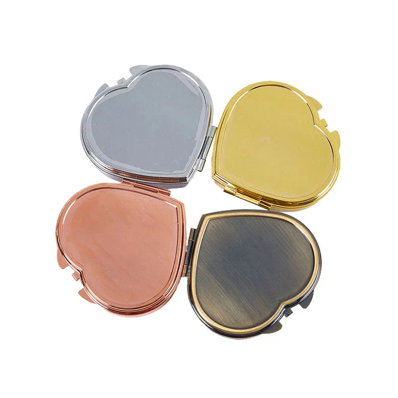 Elegant heart-shaped metal pill box with mirror for organized storage and convenient touch-ups